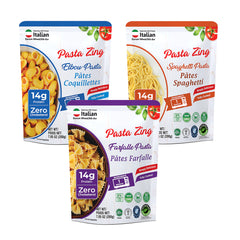 A promotional layout featuring three pouches of Pasta Zing fully cooked pasta: Elbow (blue), Spaghetti (orange), and Farfalle (purple). Each pouch prominently displays a "14g Protein" badge and a "1 Minute" microwave icon. The background is clean white, emphasizing the "Simply Delicious" red banner and the various health certifications at the bottom, including BPA Free, Non-GMO, Halal, and Kosher.